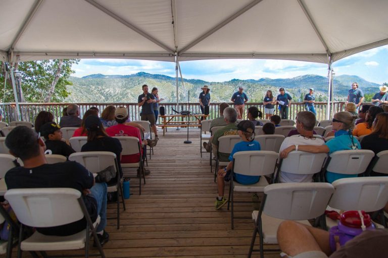 a group meeting on a mountain deck