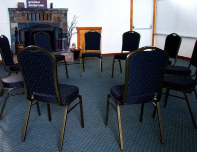 chairs arranged in a circle on a blue carpet