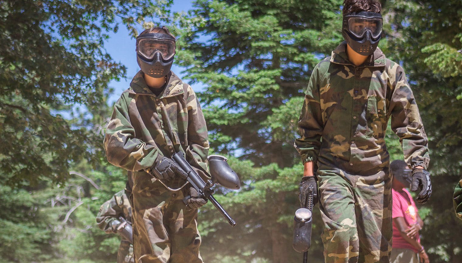 Two people in paintball gear.