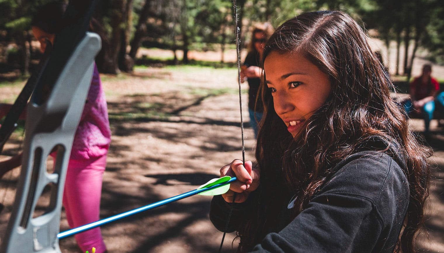 A girl holding a bow and arrow.