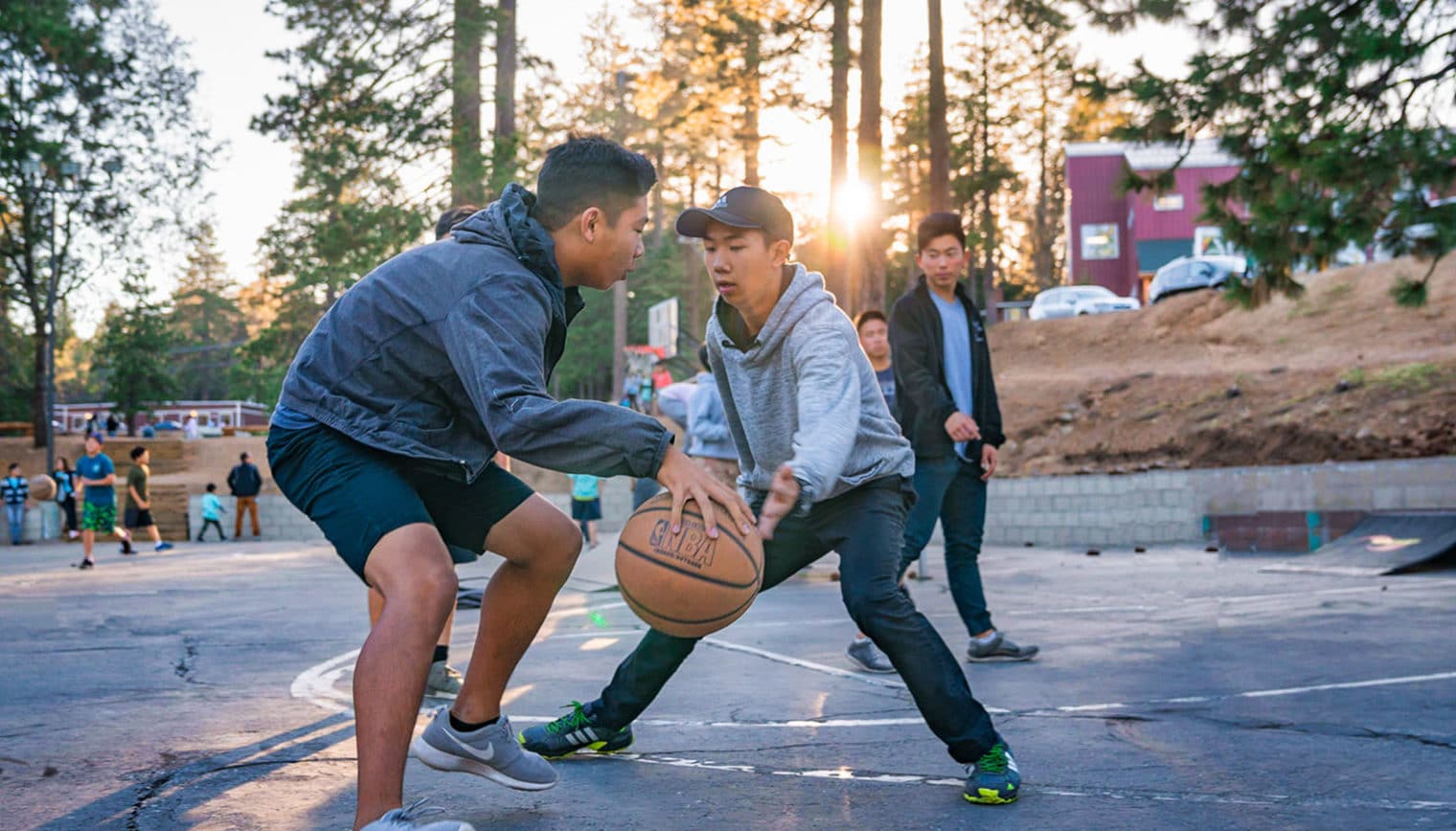 A group of people playing basketball.