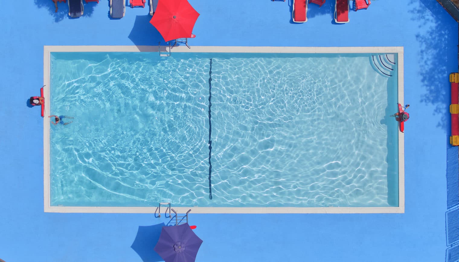 An aerial view of an outdoor swimming pool.
