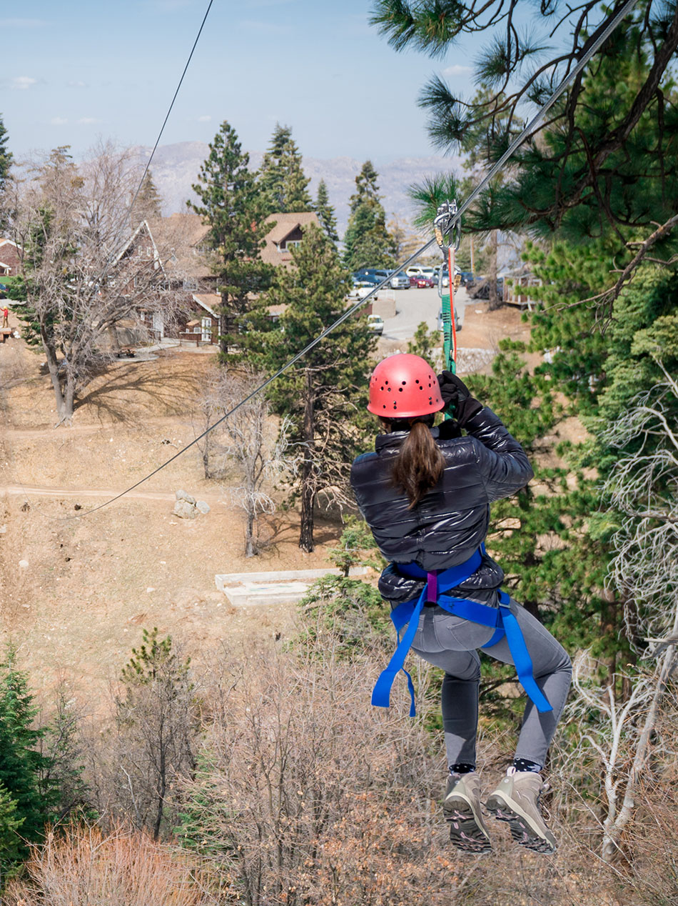 A person going down a zip line.